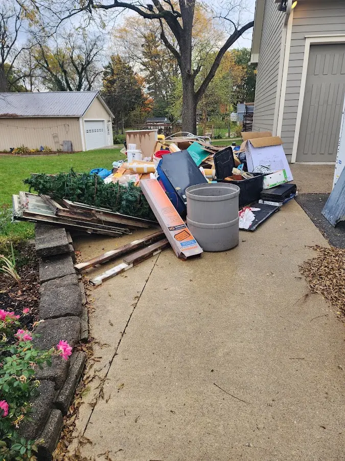 Dumpster being loaded with debris for Estate Cleanout Dumpster Rental in Morristown